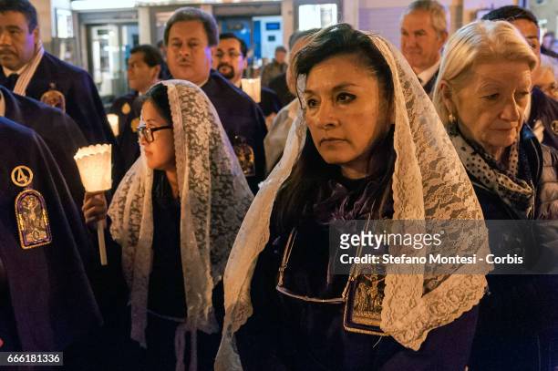 The procession of the Via Crucis of the Christian brotherhoods proceeds through the streets of the old town on April 7, 2017 in Rome, Italy. The...
