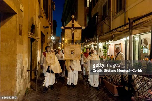 The procession of the Via Crucis of the Christian brotherhoods proceeds through the streets of the old town on April 7, 2017 in Rome, Italy. The...