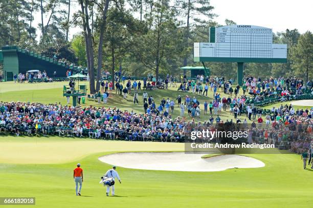 Jason Day of Australia approaches the second green with caddie Colin Swatton during the third round of the 2017 Masters Tournament at Augusta...