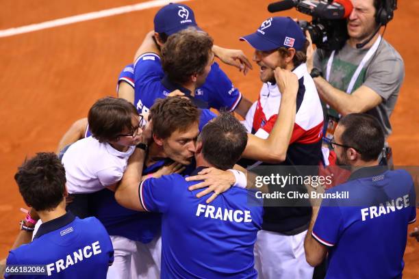 Nicolas Mahut and Julien Benneteau of France celebrate victory with team mates after the doubles match against Jamie Murray and Dominic Inglot of...