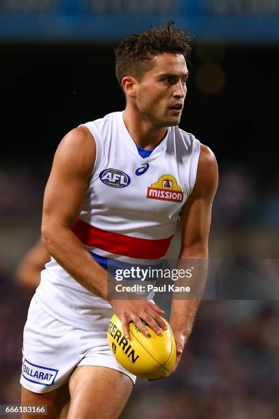 Luke Dahlhaus of the Bulldogs looks to pass the ball during the round three AFL match between the Fremantle Dockers and the Western Bulldogs at...