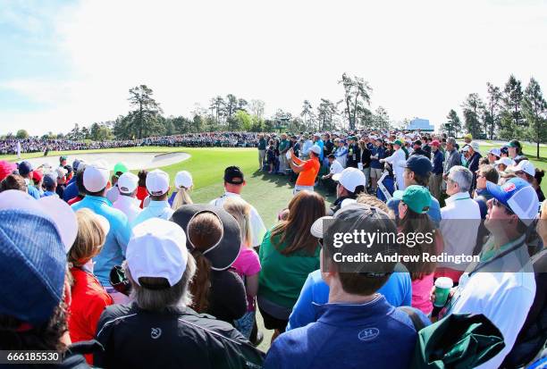 Jason Day of Australia plays a shot to the second green as patrons look on during the third round of the 2017 Masters Tournament at Augusta National...