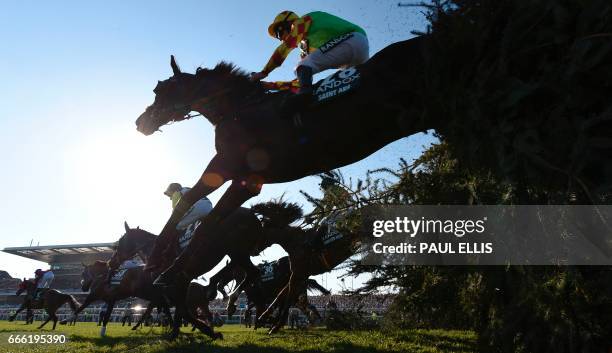 Jockey Davy Russell riding Saint Are jumps "The Chair" during the Grand National horse race on the final day of the Grand National Festival horse...