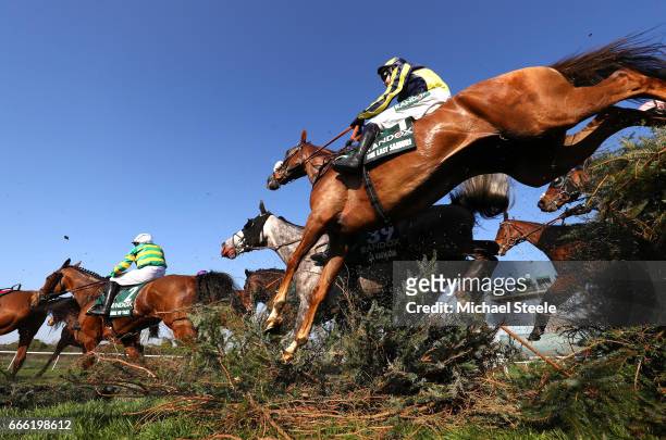 David Bass riding The Last Samuri jumps over the Canal Turn during the 2017 Randox Heath Grand National at Aintree Racecourse on April 8, 2017 in...