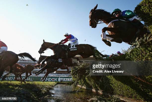 One For Arthur ridden by Derek Fox clears the Water Jump on their way to victory in the 2017 Randox Health Grand National at Aintree Racecourse on...
