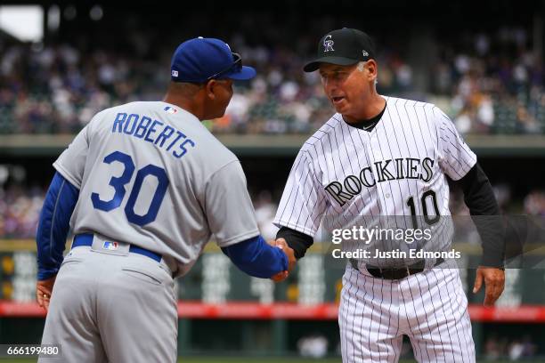 Manager Bud Black of the Colorado Rockies shakes hands with manager Dave Roberts of the Los Angeles Dodgers on Opening Day at Coors Field on April 7,...