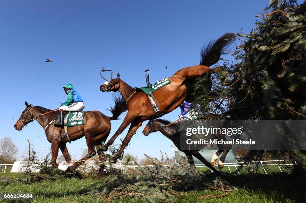 Jamie Moore riding Bishops Road goes over the Canal Turn with riderless The Young Master during the 2017 Randox Heath Grand National at Aintree...