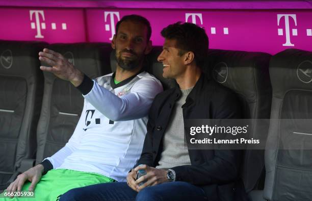 Thomas Mueller and Tom Starke of FC Bayern Muenchen joke on the bench prior to the Bundesliga match between Bayern Muenchen and Borussia Dortmund at...