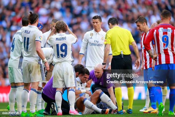 Pepe of Real Madrid CF grimmaces in pain after clashing with his teammate Toni Kroos during the La Liga match between Real Madrid CF and Club...