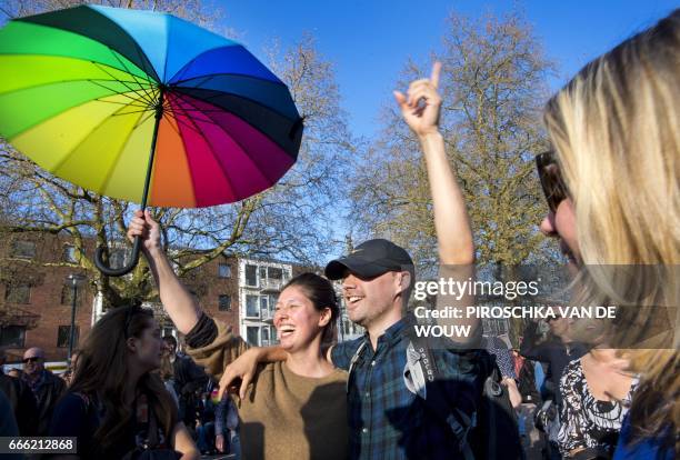 Participants are pictured during the 'Hand in Hand for Diversity' demonstration against anti-LGBT violence in Arnhem, The Netherlands, on April 8,...