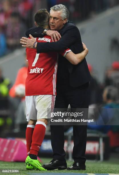 Franck Ribery of Bayern Muenchen and Carlo Ancelotti, Manager of Bayern Muenchen embrace after he is subbed during the Bundesliga match between...