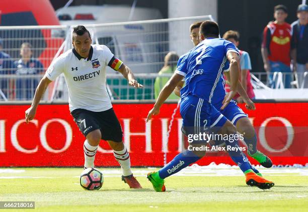 Esteban Paredes of Colo Colo fights for the ball with Christian Vilches of U de Chile during a match between U de Chile and Colo Colo as part of...