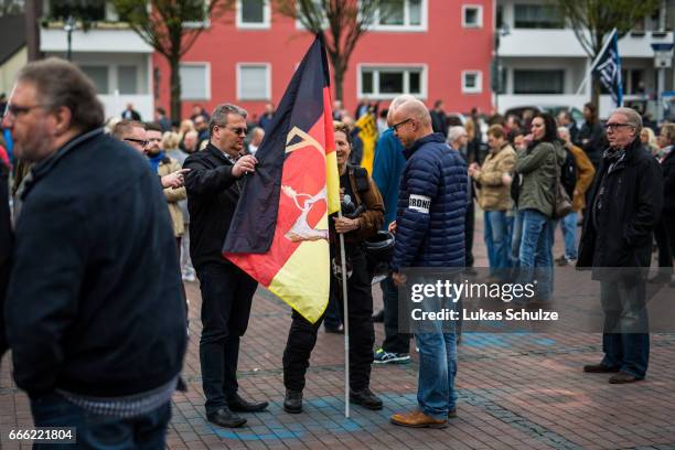 Stewards of the Alternative fuer Deutschland right-wing, populist political party, check a flag of a supporter depicting the hands of German...