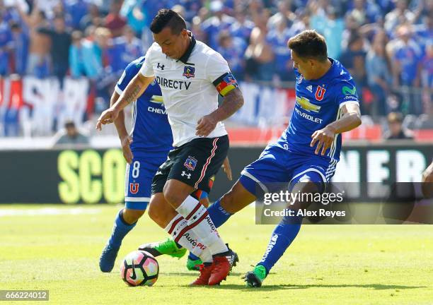 Esteban Paredes of Colo Colo fights for the ball with Matias Rodriguez of U de Chile during a match between U de Chile and Colo Colo as part of...