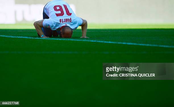 Former sports director of FC Sevilla Ramon Rodriguez Berdejo 'Monchi' kisses the field during his farewell before the Spanish league football match...