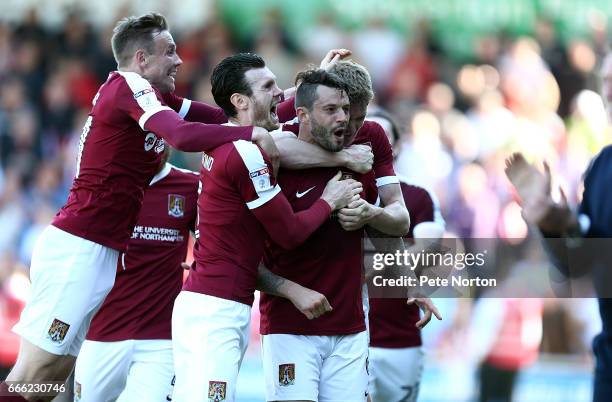 Marc Richards of Northampton Town celebrates with team mates Zander Diamond, Matt Taylor and Michael Smith after scoring his sides first goalduring...