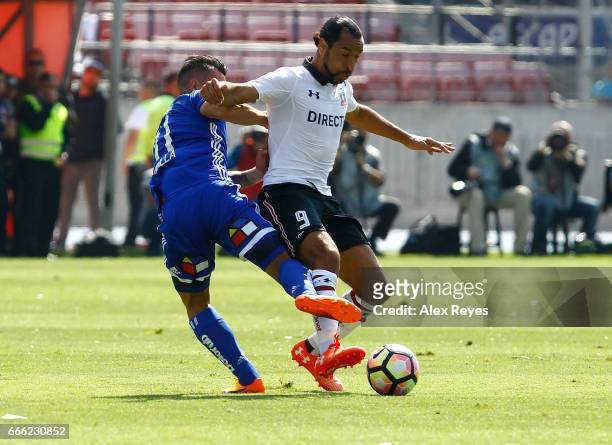 Luis Pedro Figueroa of Colo Colo struggles for the ball with Sebastian Ubilla of U de Chile during a match between U de Chile and Colo Colo as part...