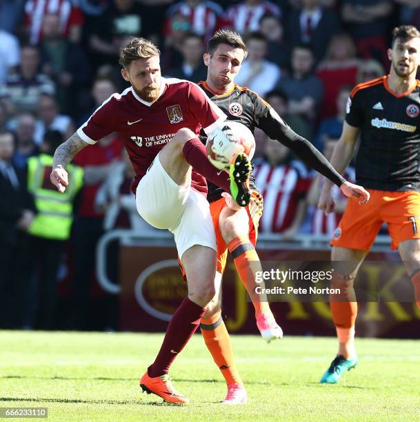 Paul Anderson of Northampton Town contests the ball with Daniel Lafferty of Sheffield United during the Sky Bet League One match between Northampton...