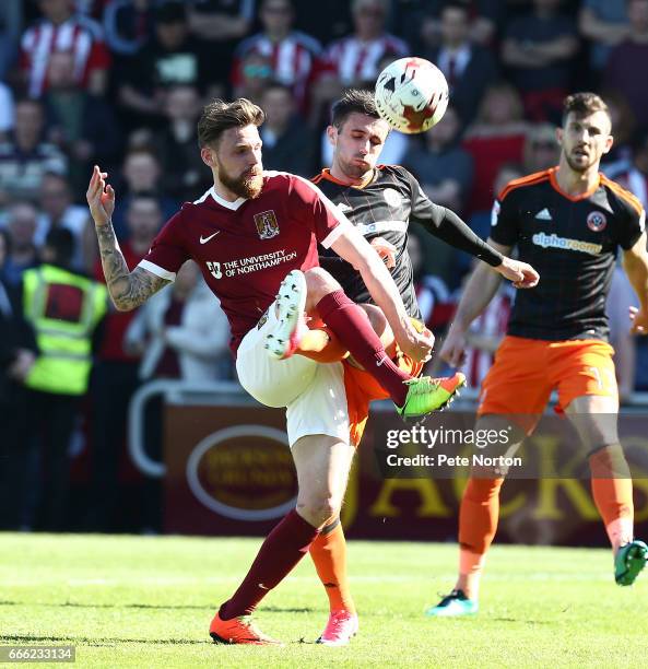 Paul Anderson of Northampton Town contests the ball with Daniel Lafferty of Sheffield United during the Sky Bet League One match between Northampton...
