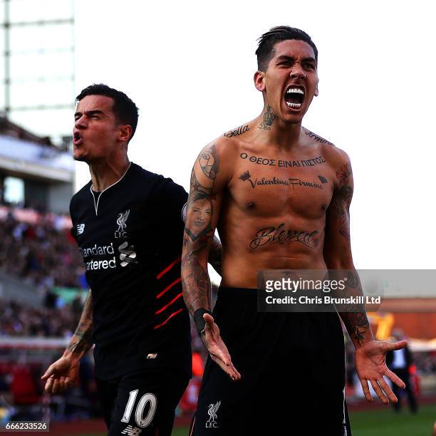 Roberto Firmino of Liverpool celebrates scoring his side's second goal with team-mate Philippe Coutinho during the Premier League match between Stoke...