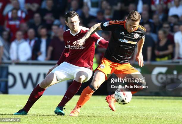 Billy Sharp of Sheffield United attempts to control the ball watched by Zander Diamond of Northampton Town during the Sky Bet League One match...