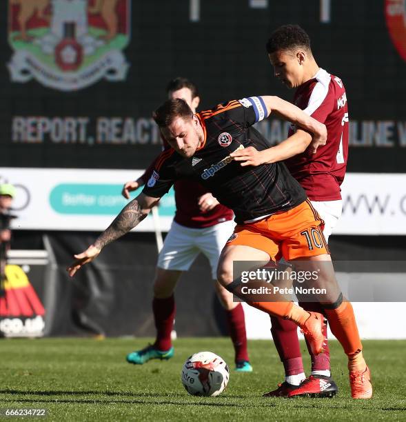 Billy Sharp of Sheffield United attempts to control the ball under pressure from Shaun McWilliams of Northampton Town during the Sky Bet League One...