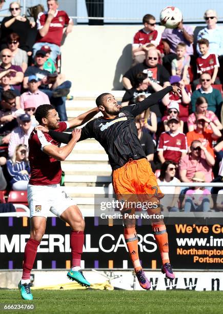 Lewin Nyatanga of Northampton Town contests the ball with Leon Clarke of Sheffield United during the Sky Bet League One match between Northampton...