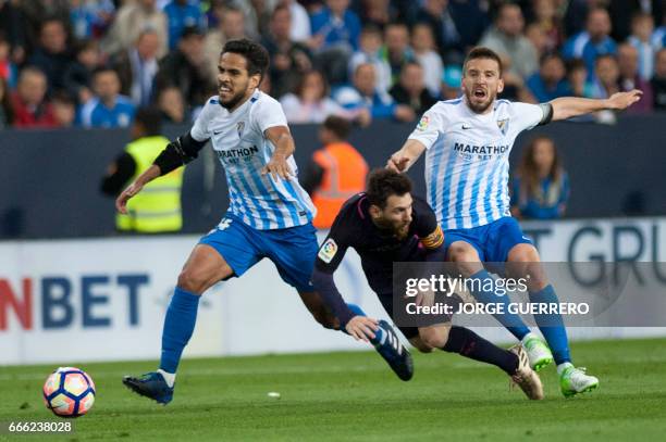 Malaga's midfielder Jose Luis Garcia Recio and midfielder Ignacio Camacho vie with Barcelona's Argentinian forward Lionel Messi during the Spanish...