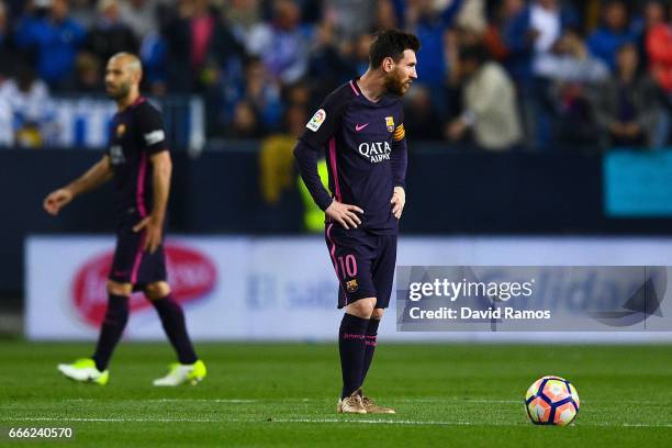 Lionel Messi of FC Barcelona reacts dejected after Sandro Ramirez of Malaga CF scored the opening goal during the La Liga match between Malaga CF and...