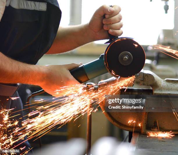 man working with grinder in workshop - grinding machine stock pictures, royalty-free photos & images