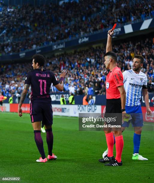 Neymar Jr. Of FC Barcelona is shown a red card during the La Liga match between Malaga CF and FC Barcelona at La Rosaleda stadium on April 8, 2017 in...