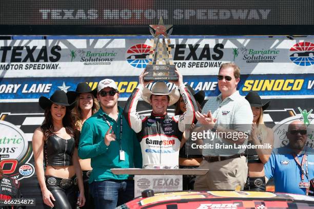 Erik Jones, driver of the GameStop/GAEMS Toyota, celebrates with the trophy in Victory Lane after winning the NASCAR XFINITY Series My Bariatric...