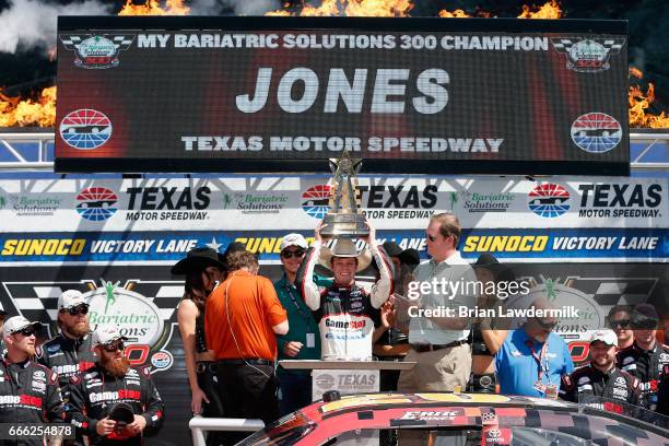 Erik Jones, driver of the GameStop/GAEMS Toyota, celebrates with the trophy in Victory Lane after winning the NASCAR XFINITY Series My Bariatric...