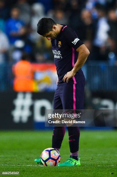 Luis Suarez of FC Barcelona looks on dejected after Jony Rodriguez of Malaga CF scored his team's second goal during the La Liga match between Malaga...