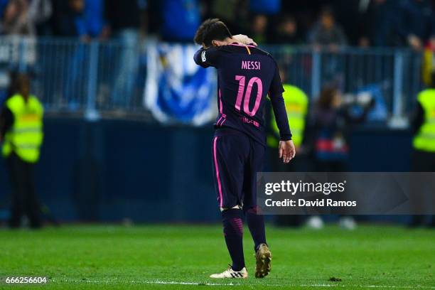 Lionel Messi of FC Barcelona looks on dejected after Jony Rodriguez of Malaga CF scored his team's second goal during the La Liga match between...