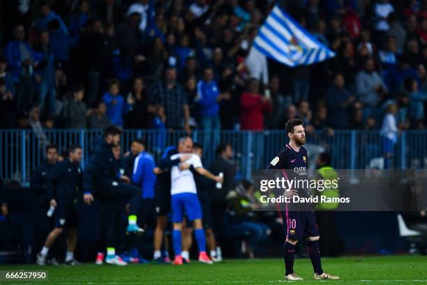 Lionel Messi of FC Barcelona looks on dejected after Jony Rodriguez of Malaga CF scored his team's second goal during the La Liga match between...