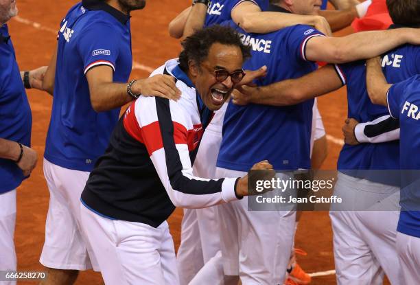 Captain of France Yannick Noah and his players and staff celebrate the victory 3-0 following the doubles match during the Davis Cup World Group...