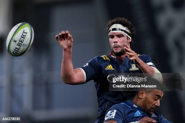 Tom Franklin of the Highlanders passes the ball from a lineout during the round seven Super Rugby match between the Highlanders and the Blues on...