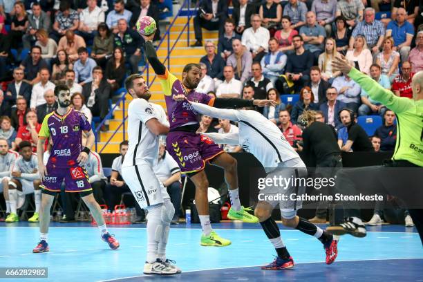 Nicolas Claire of HBC Nantes is trying to shoot the ball against Luka Karabatic and Luka Stepancic of Paris Saint Germain during the final match of...