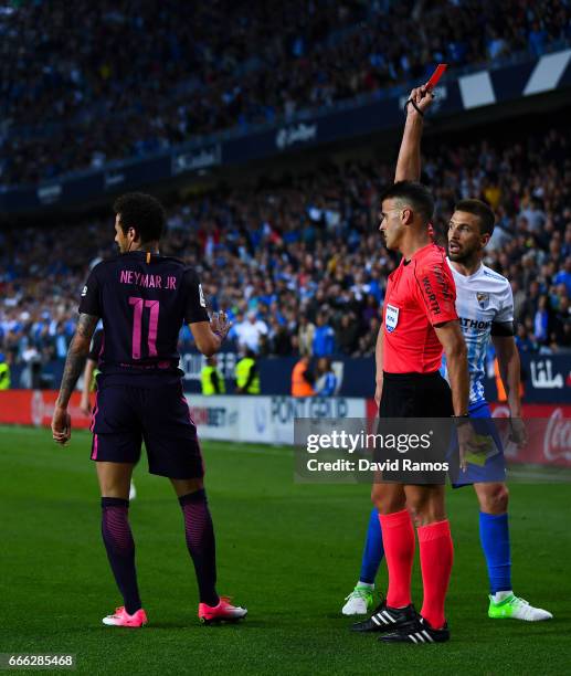 Neymar Jr. Of FC Barcelona is shown a red card during the La Liga match between Malaga CF and FC Barcelona at La Rosaleda stadium on April 8, 2017 in...