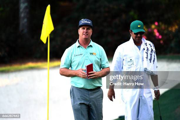 Charley Hoffman of the United States and caddie Brett Waldman walk off the 13th hole during the third round of the 2017 Masters Tournament at Augusta...