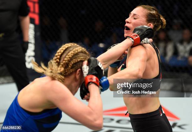 Katlyn Chookagian lands a punch on Irene Aldana of Mexico in their women's bantamweight bout during the UFC 210 event at KeyBank Center on April 8,...