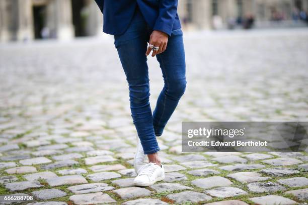 Theo Kimbaloula, fashion blogger, wears a Zara blue blazer jacket, Asos blue jeans, and Jules white sneakers shoes, at the Louvre, on April 2, 2017...