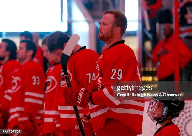 The Carolina Hurricanes' Bryan Bickell stands during the national anthem before the final home game of the season, against the St. Louis Blues, at...