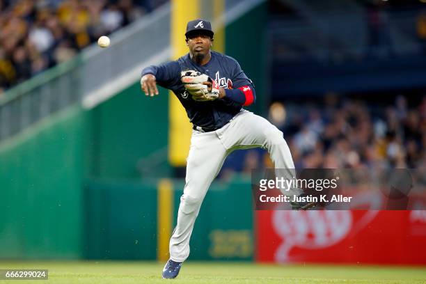 Adonis Garcia of the Atlanta Braves makes a throwing error in the second inning against the Pittsburgh Pirates at PNC Park on April 8, 2017 in...