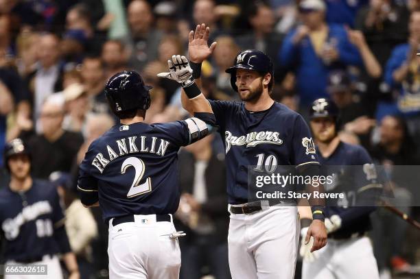 Nick Franklin of the Milwaukee Brewers is congratulated by Kirk Nieuwenhuis following a home run against the Chicago Cubs during the fourth inning of...