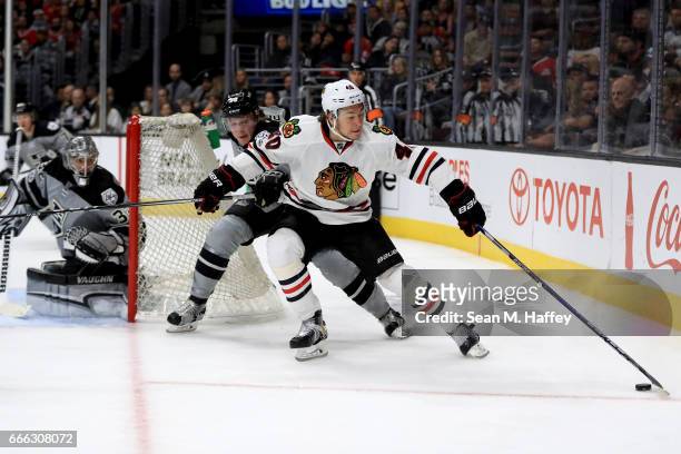 John Hayden of the Chicago Blackhawks skates past Paul LaDue of the Los Angeles Kings during the third period of a game at Staples Center on April 8,...