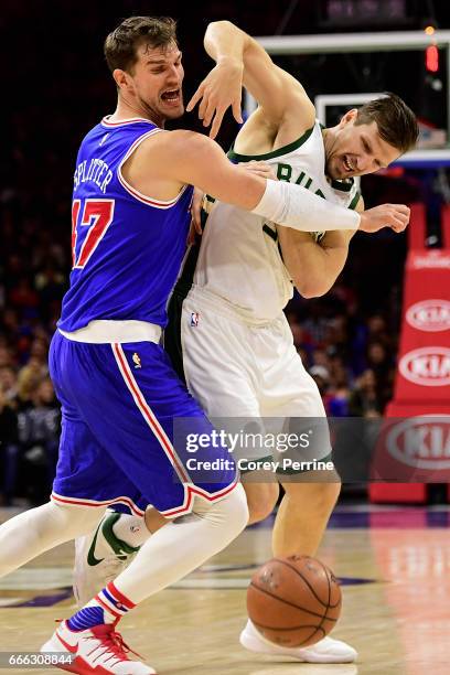 Tiago Splitter of the Philadelphia 76ers and Mirza Teletovic of the Milwaukee Bucks fight for a loose ball during the fourth quarter at the Wells...