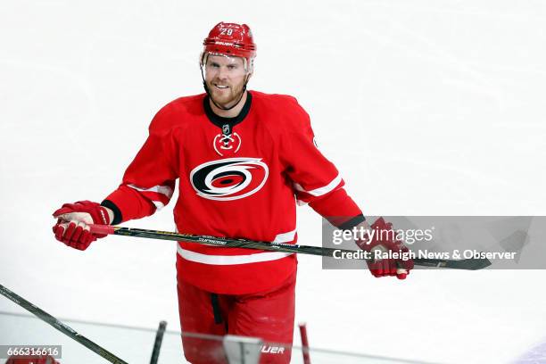 The Carolina Hurricanes' Bryan Bickell smiles at the crowd as he is recognized during the third period of a game against the St. Louis Blues at PNC...