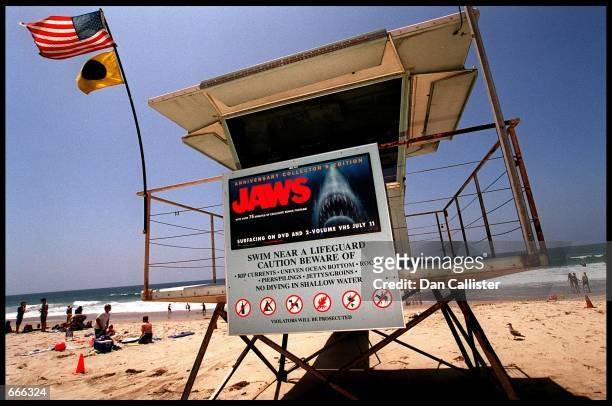 Poster advertising the anniversary collector's edition of the movie "Jaws" is posted on a lifeguard tower July 2, 2000 on Zuma Beach in Malibu, CA....